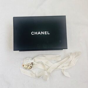 Chanel box with flower on ribbon and tissue paper